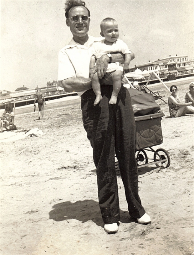 Man with Comb Over Holding a Baby at the Beach
